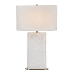 A white marble table lamp base with a natural honed finish, featuring a classic E26 socket, a dimmer switch, and an off-white linen shade, complemented by a brushed brass finished iron stem.