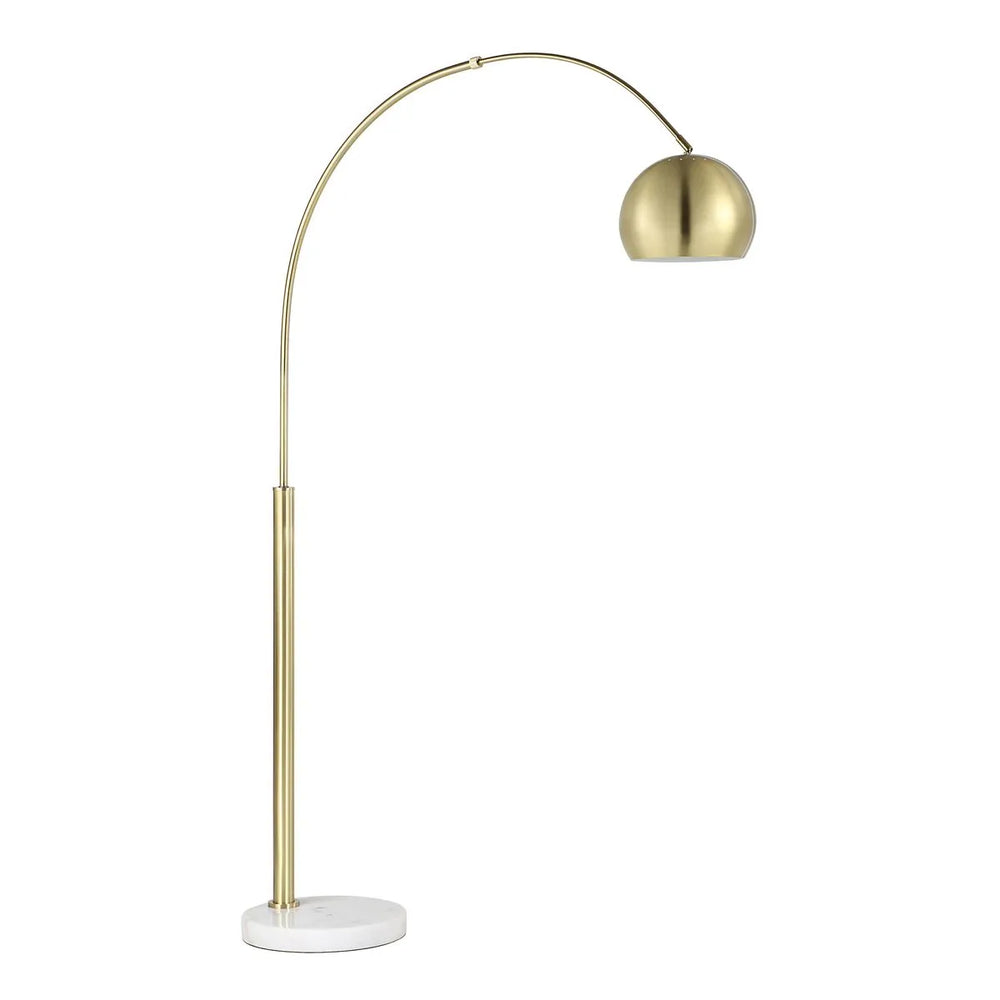 A gold-colored floor lamp with a dome-shaped shade, positioned on a white cylindrical base.