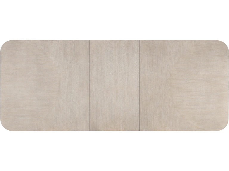 Top of a rectangular dining table with a light wood finish on a white background