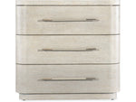 A beige nightstand with three drawers, each having a metal handle.