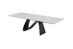 A contemporary extendable dining table with a white marble top and black base, shown in a fully extended state.
