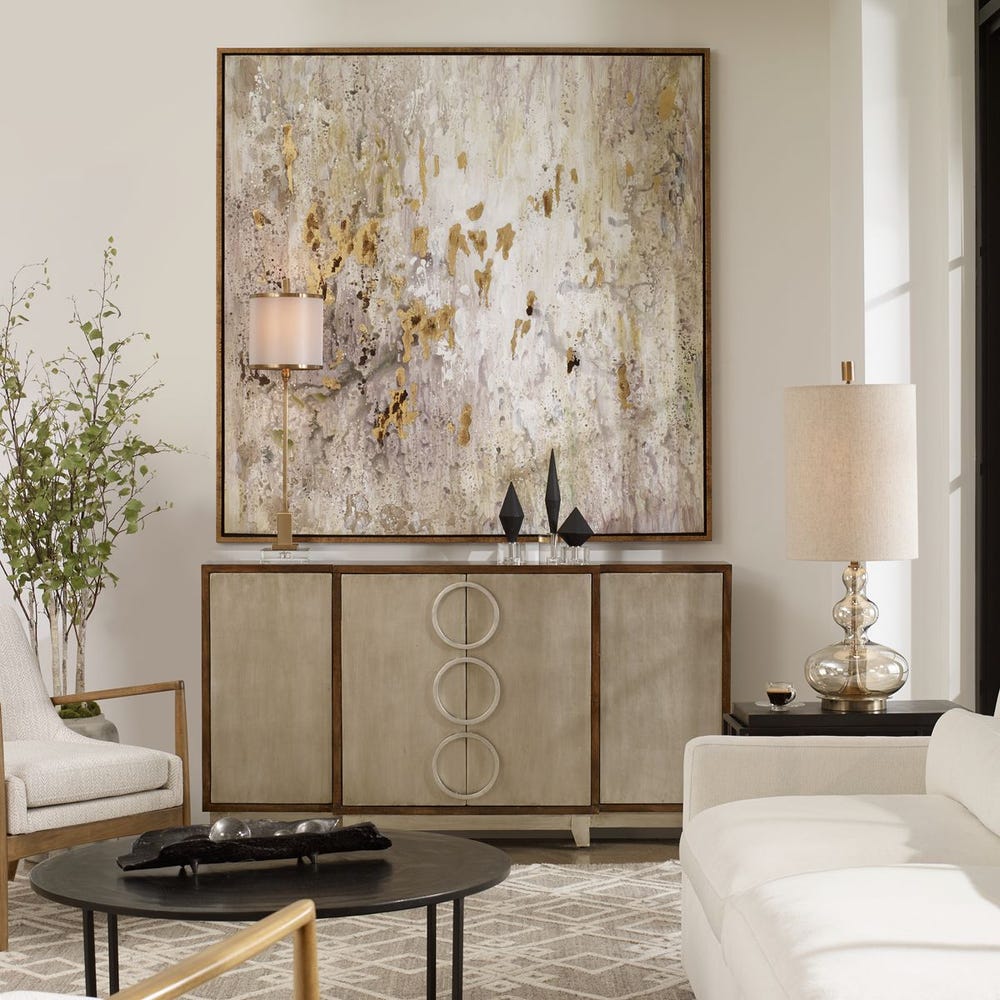 Modern living room with abstract art, sideboard, and white sofa.