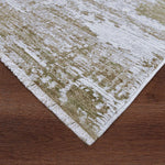 Textured green and white rug on a wooden floor