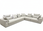 Gray sectional sofa with multiple cushions on a white background