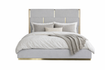 Gray upholstered bed with gold accents and white bedding on a white background