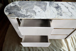 Modern side table with marble top and white drawers