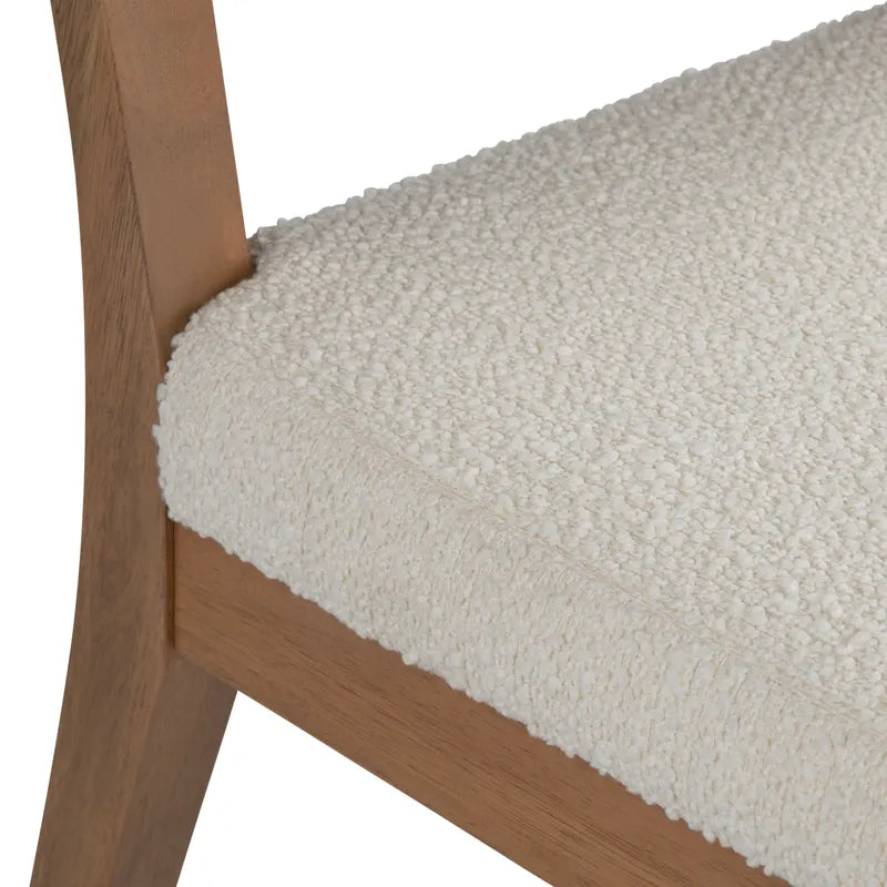 Close-up of a textured beige cushion on a wooden chair