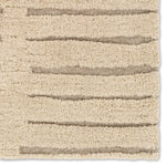 Textured beige rug with horizontal stripes on a plain background