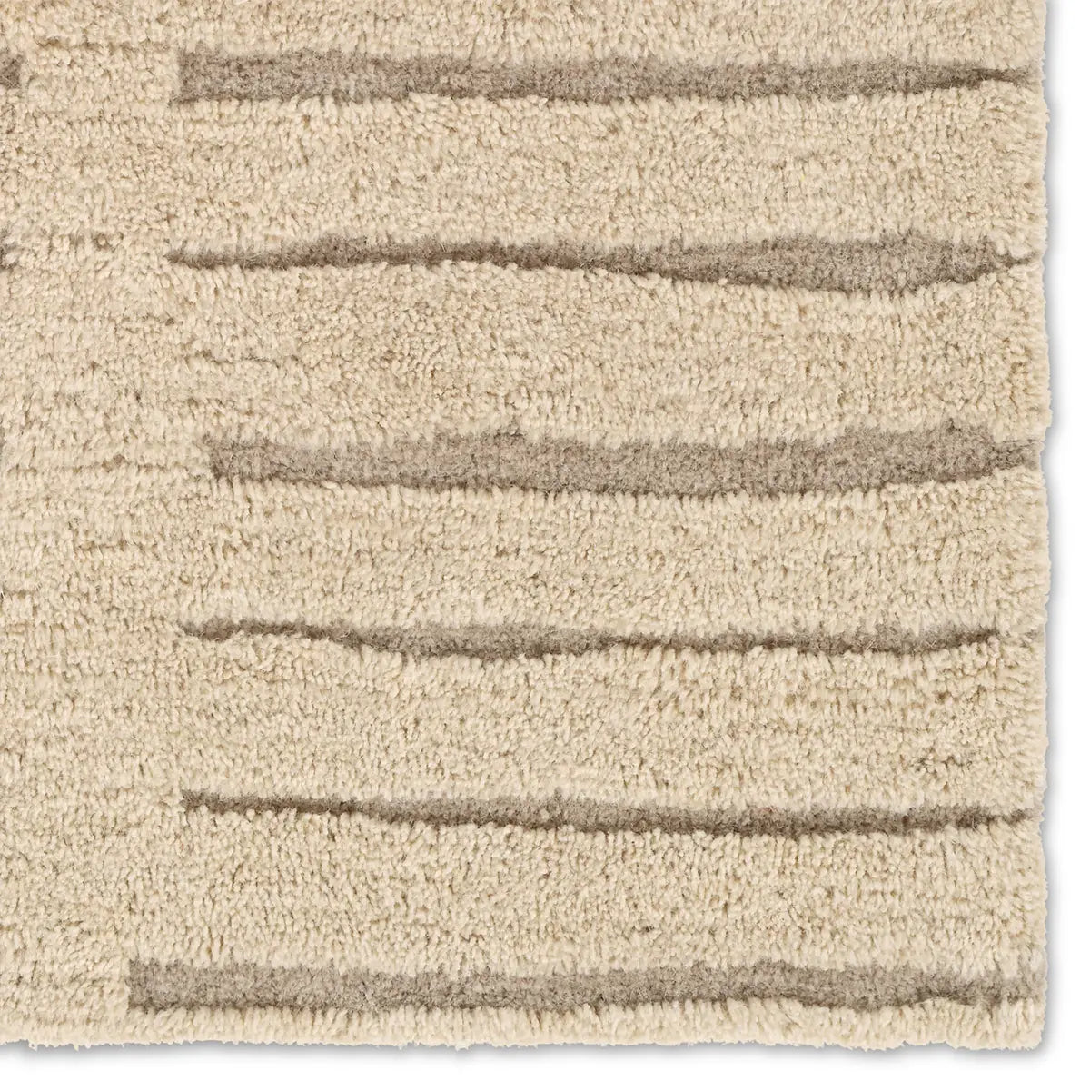 Textured beige rug with horizontal stripes on a plain background