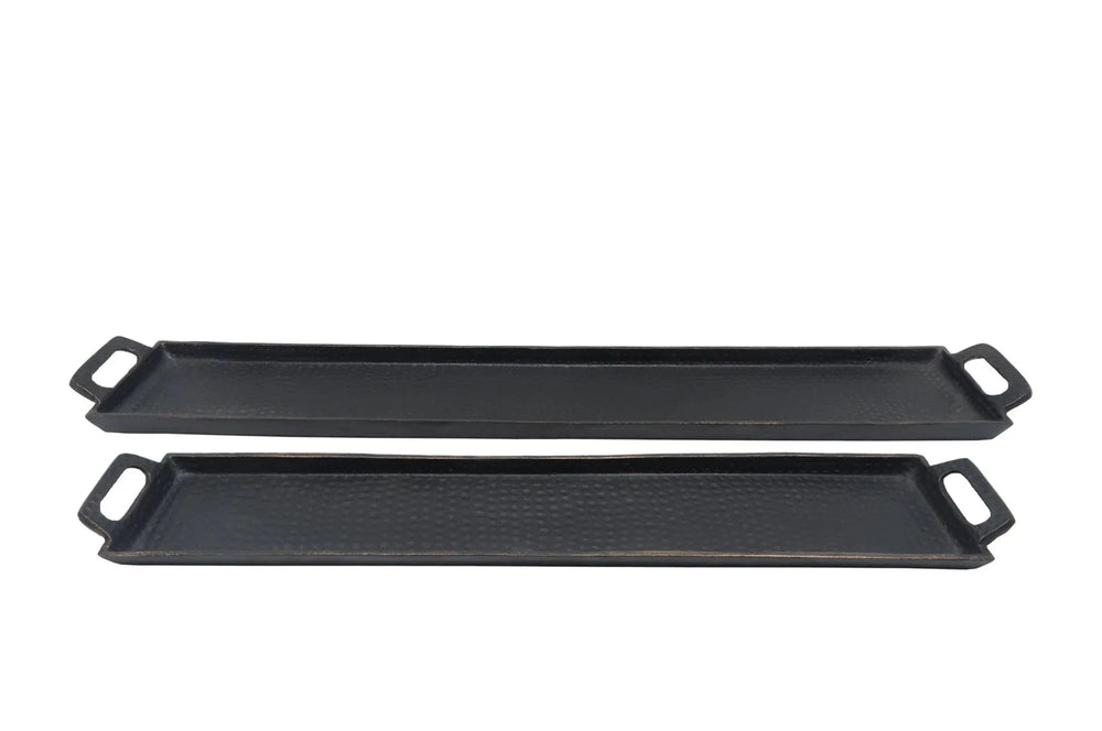 Two black griddle pans on a white background