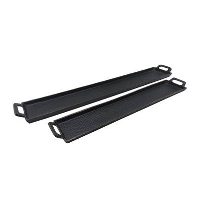 Two black griddle pans on a white background