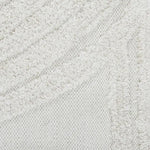 An off-white, hand woven cotton area rug with a geometric pattern and fringe edge.