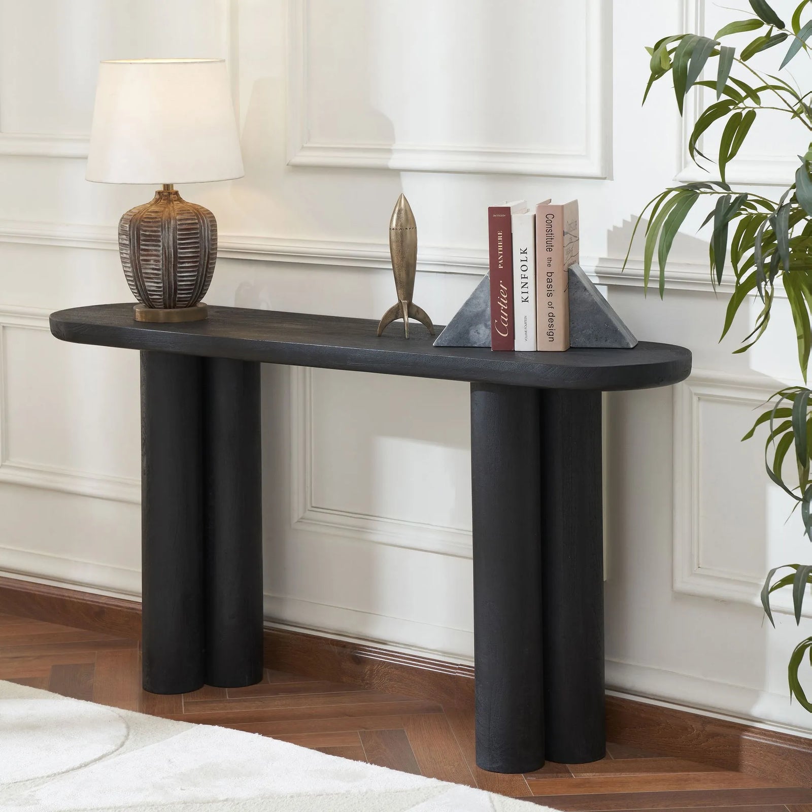 Modern black console table with decorative items in a room setting