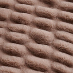 Close-up of textured brown fabric with wavy pattern
