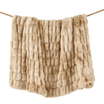 Beige textured blanket draped over a wooden stick on a white background