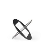 A round, black metal decorative object with a geometric design.