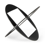 A round, black metal decorative object with a geometric design.