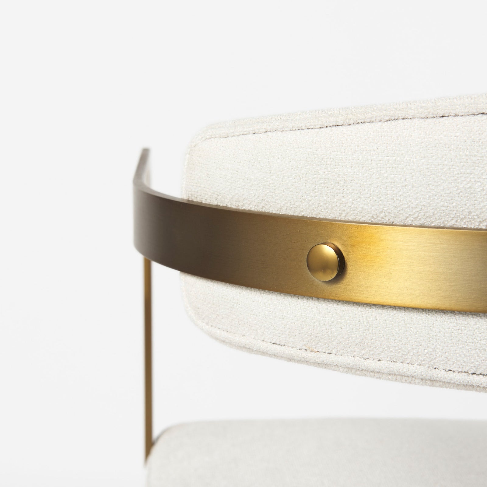 Chair with white cushioned seat and backrest on a gold metal frame against a white background