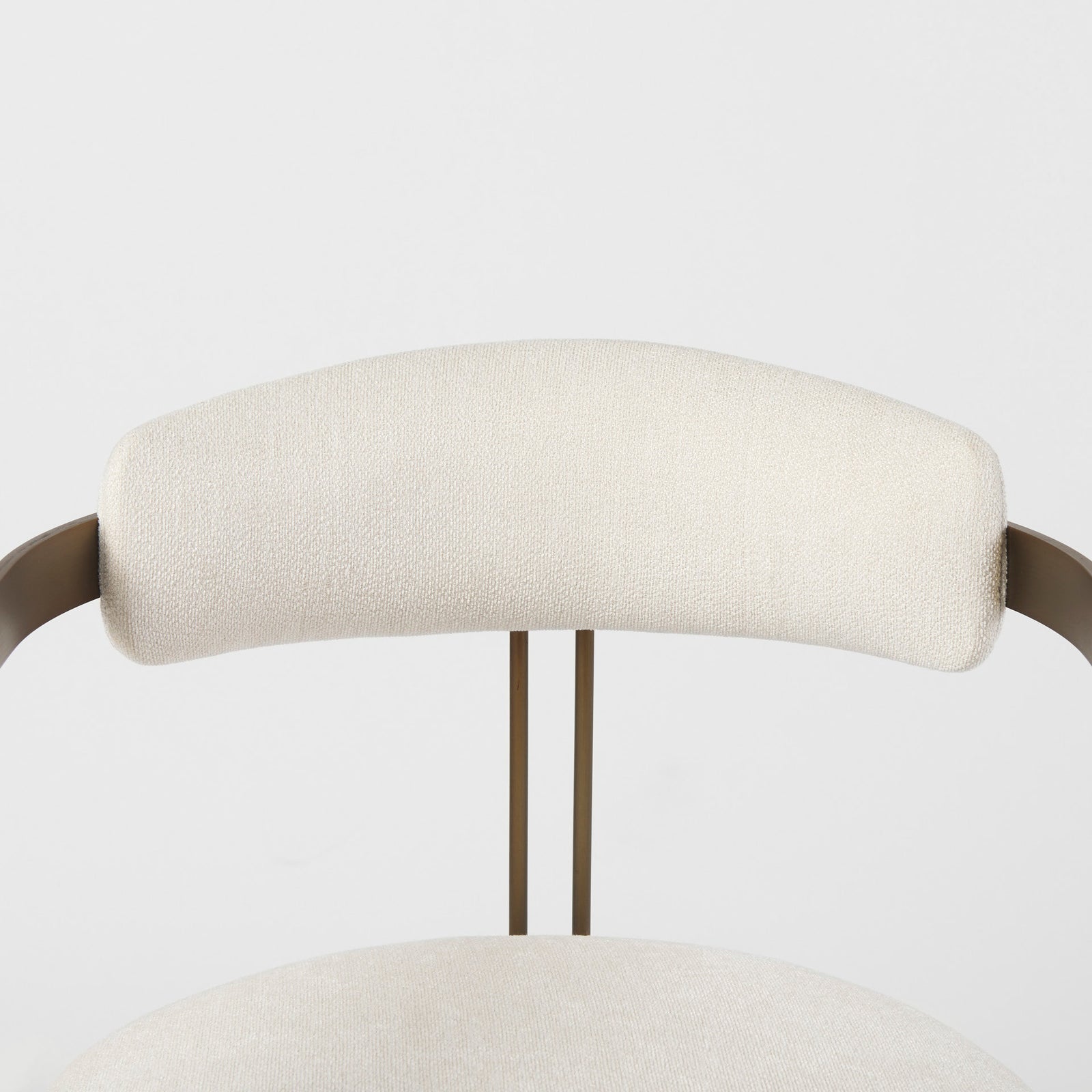 Chair with white cushioned seat and backrest on a gold metal frame against a white background