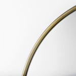 Close up to a full-length mirror with gold finished on a white background