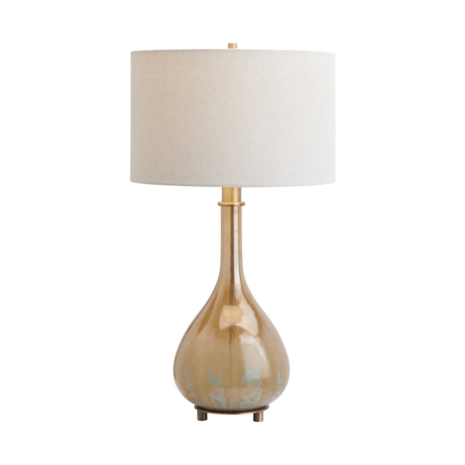 A table lamp with a tapered drum shade in off-white linen, a polished gold-finished stem, and a pear-shaped base in a warm champagne-gold tone with subtle distressed blue-green patina details near the bottom, set against a plain white background.