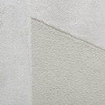 Close-up of a textured light gray fabric with a subtle pattern