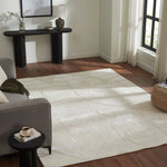 Living room with a large white rug, gray sofa, and black console table.
