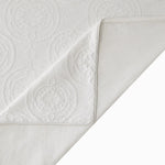 White textured fabric with a subtle pattern on a white background