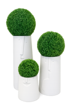 Three artificial topiary balls in white cylindrical pots on a white background