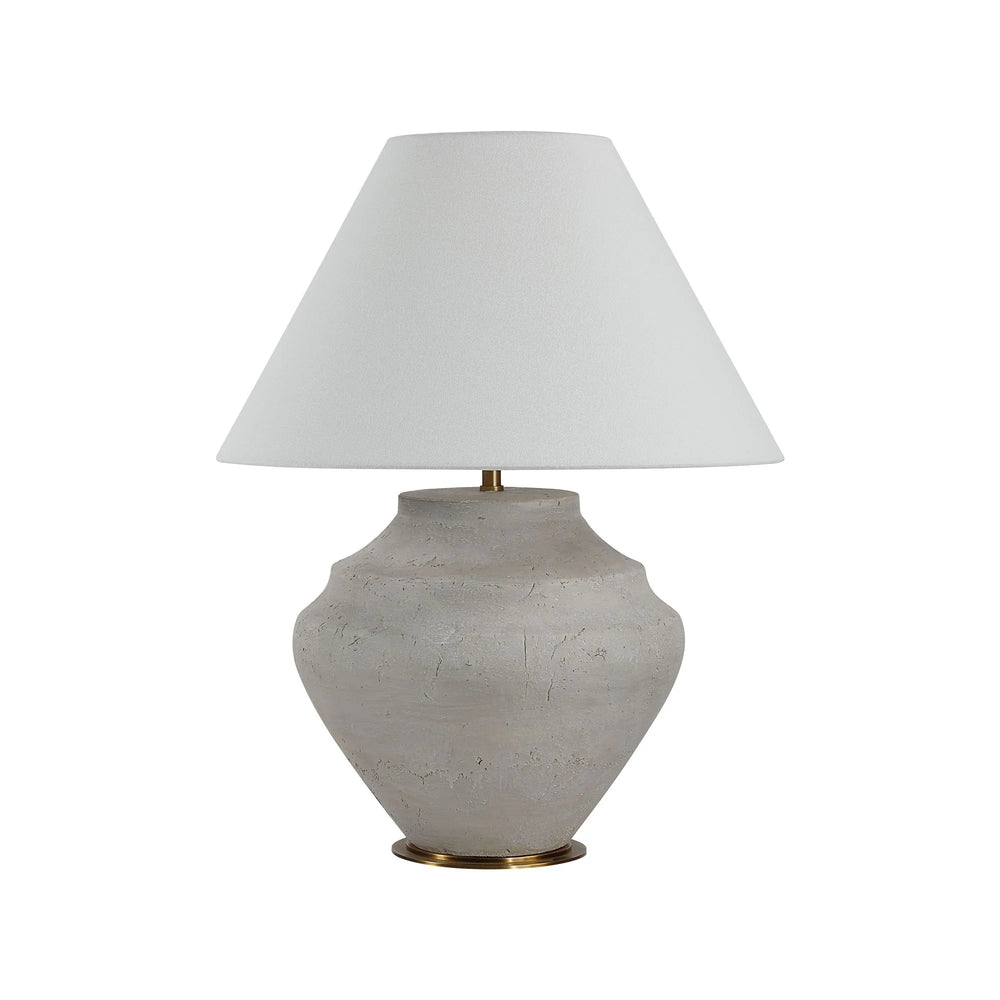 Table lamp with a textured white base and white shade on a white background