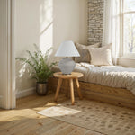 Nursery room with wooden floor, bed, and decorative elements