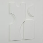 Abstract white sculpture on a light gray background