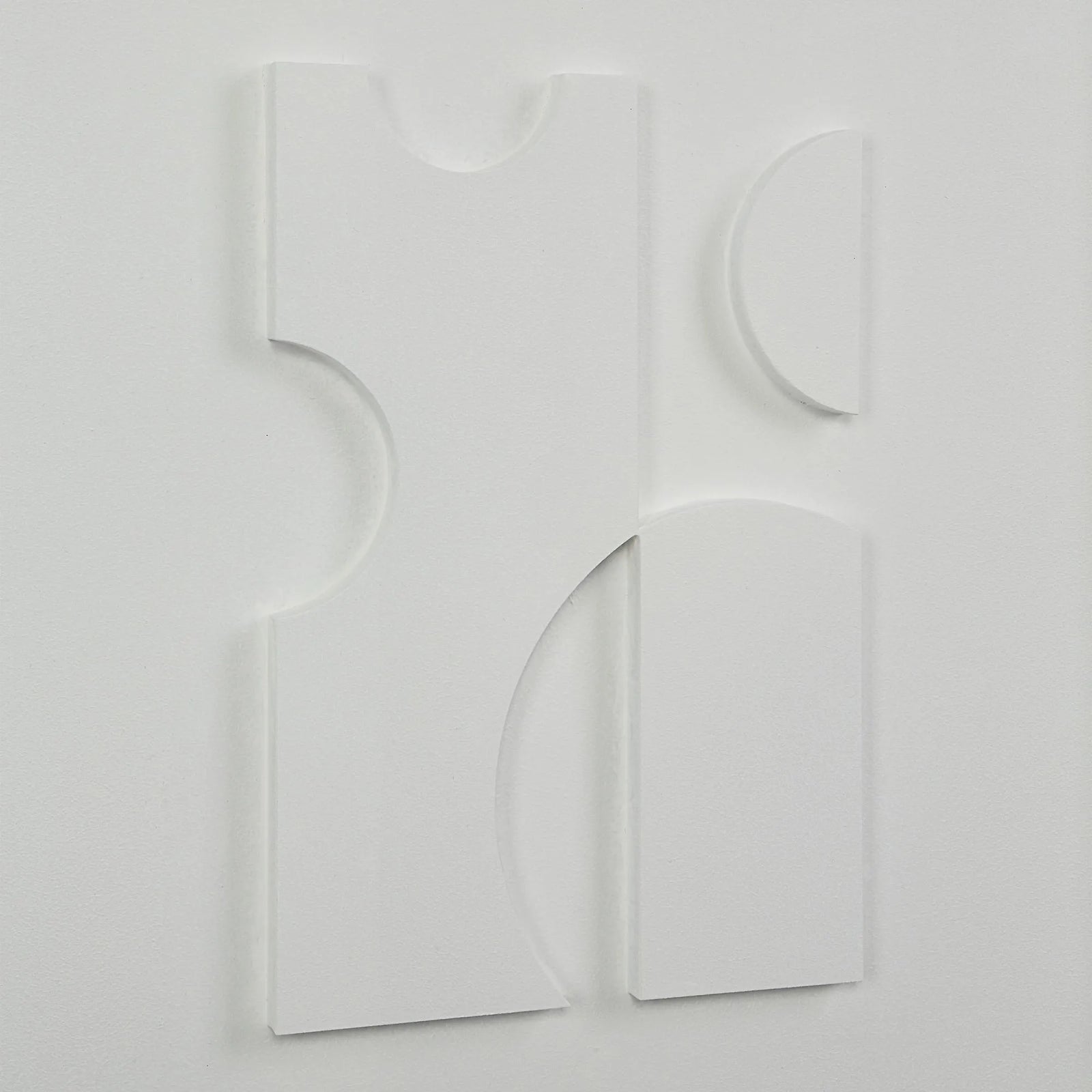 Abstract white sculpture on a light gray background