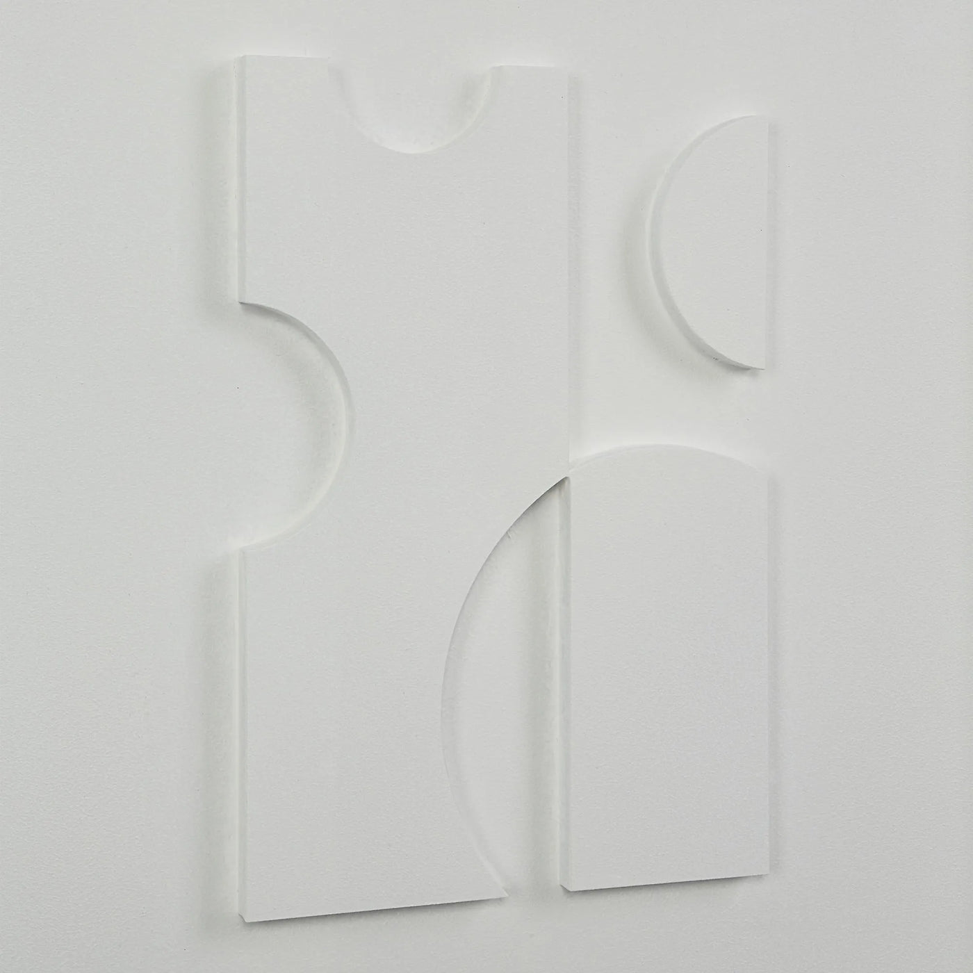 Abstract white sculpture on a light gray background