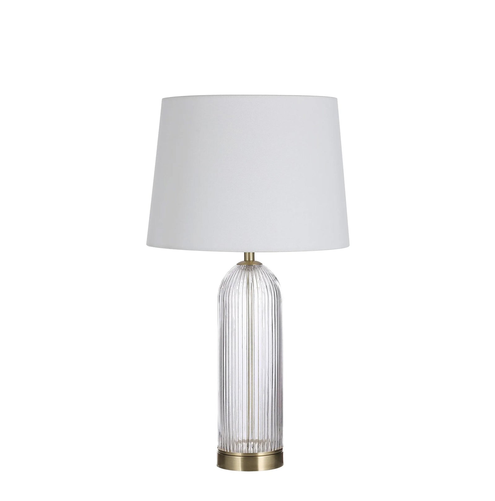 Table lamp with white shade and glass base on a white background