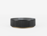 Round black coffee table with ribbed texture on a white background