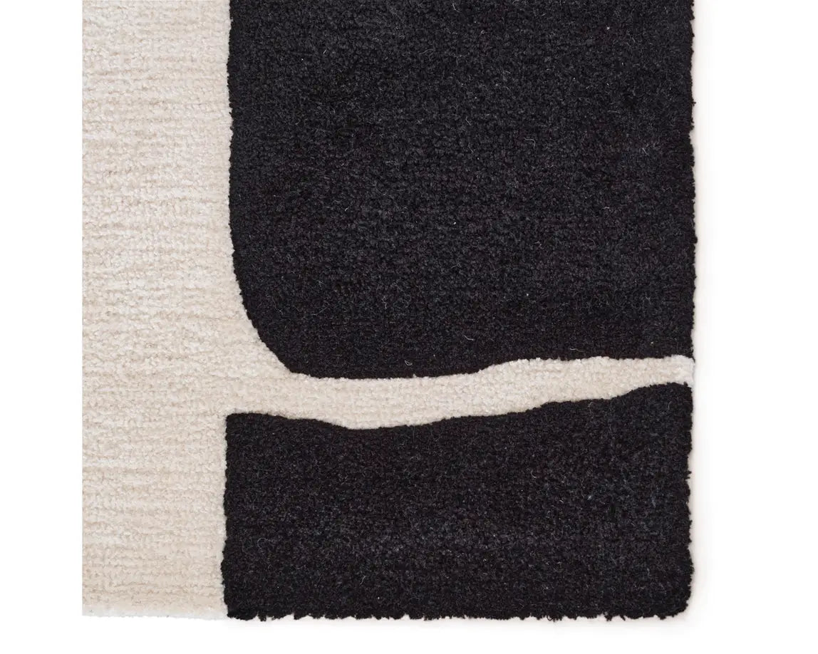 A black and white geometric patterned area rug.