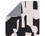 A black and white geometric patterned area rug.