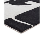 A black and white geometric patterned area rug.
