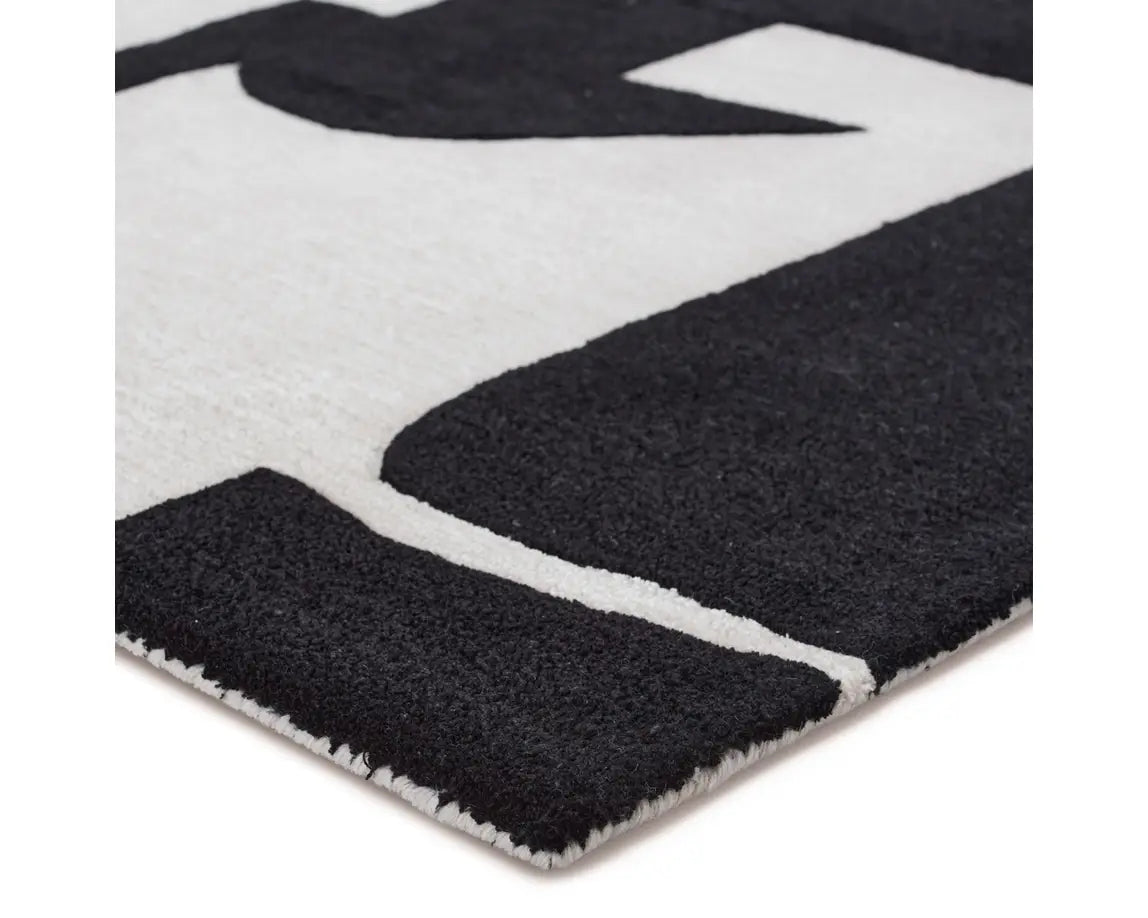 A black and white geometric patterned area rug.