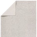 Gray textured rug corner on a white background