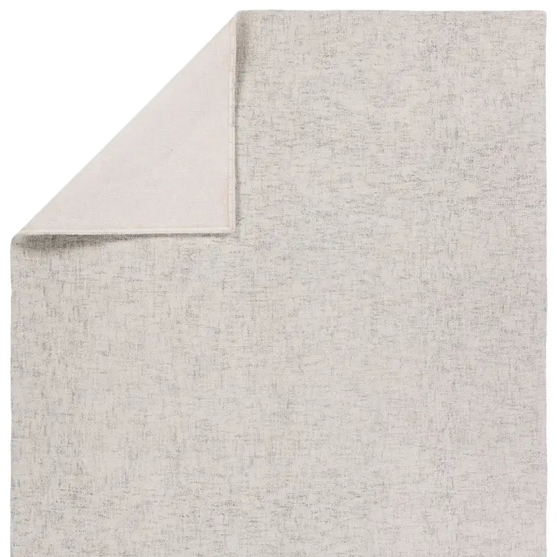 Gray textured rug corner on a white background