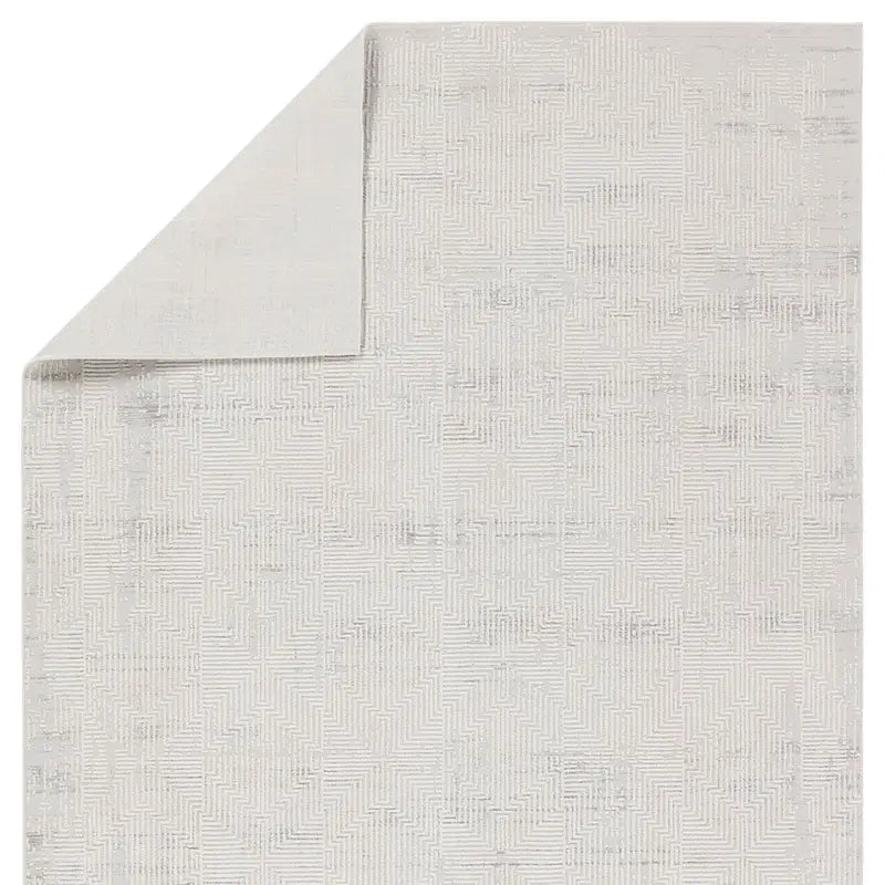 Textured gray rug with a subtle pattern on a white background
