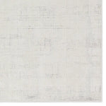 Textured white rug with geometric pattern on a plain background