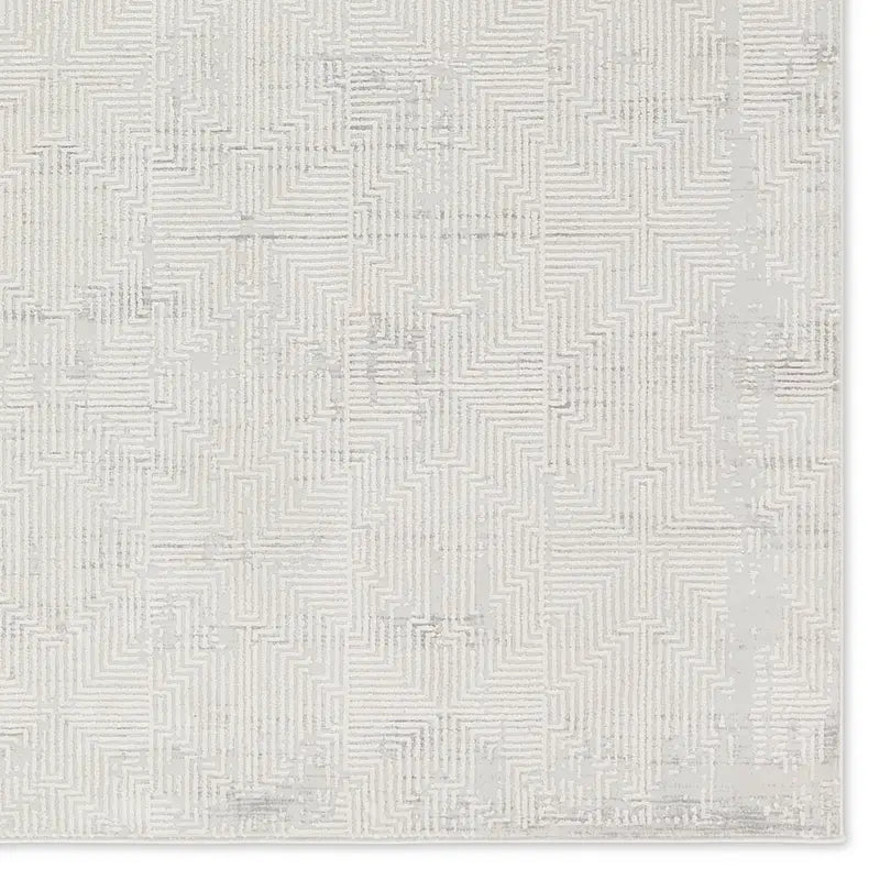 Textured white rug with geometric pattern on a plain background