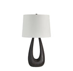 Table lamp with a dark wooden base and white lampshade on a white background