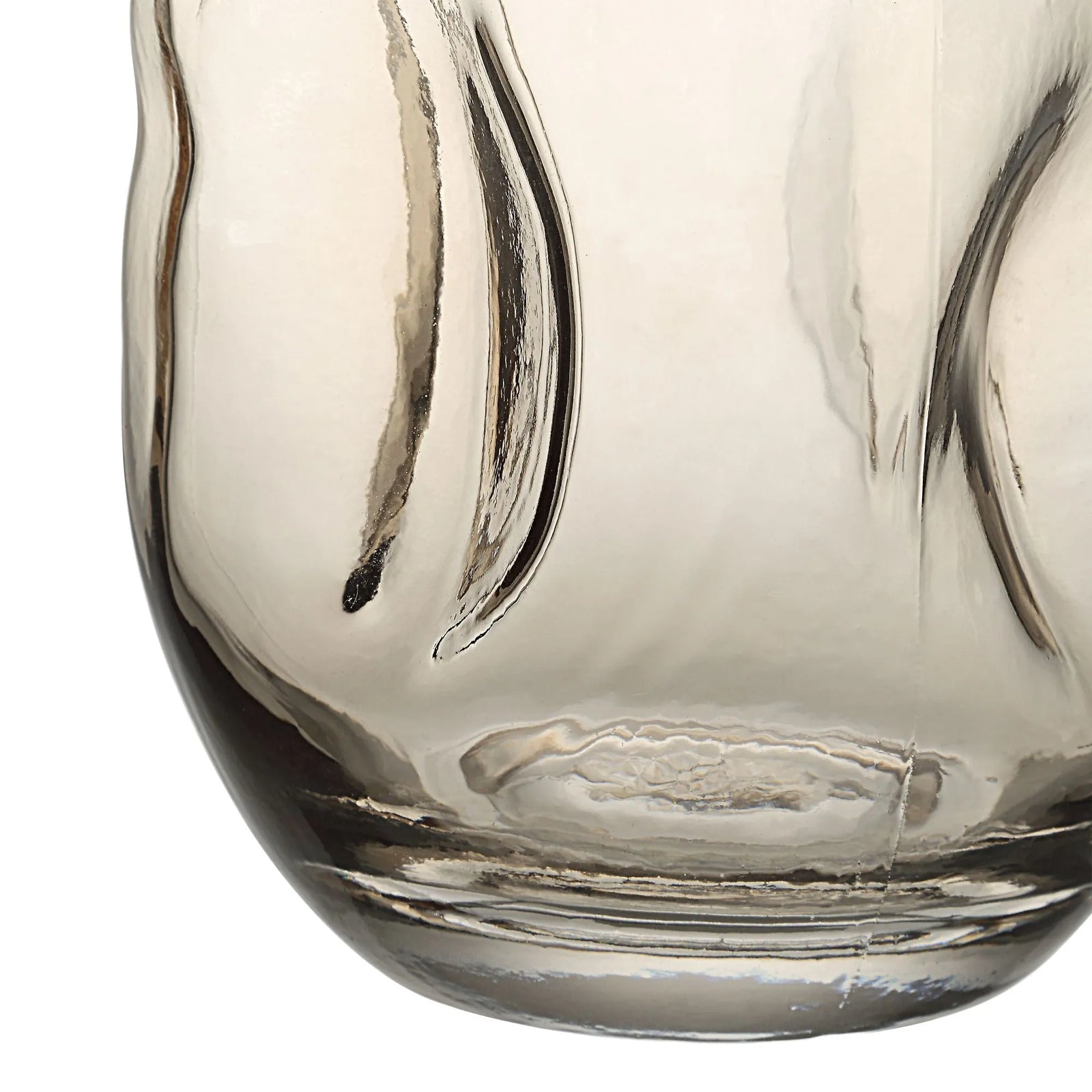 Closed-up to a beige tinted finish glass vase with a tapered design.