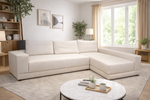 Modern living room with a beige sectional sofa, round coffee table, and decorative elements.