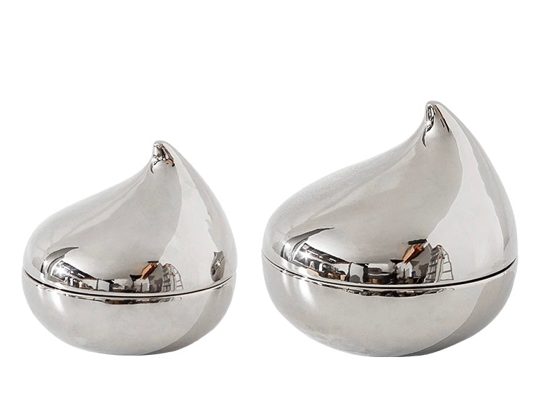 Two silver decorative jars with a teardrop shape on a white background