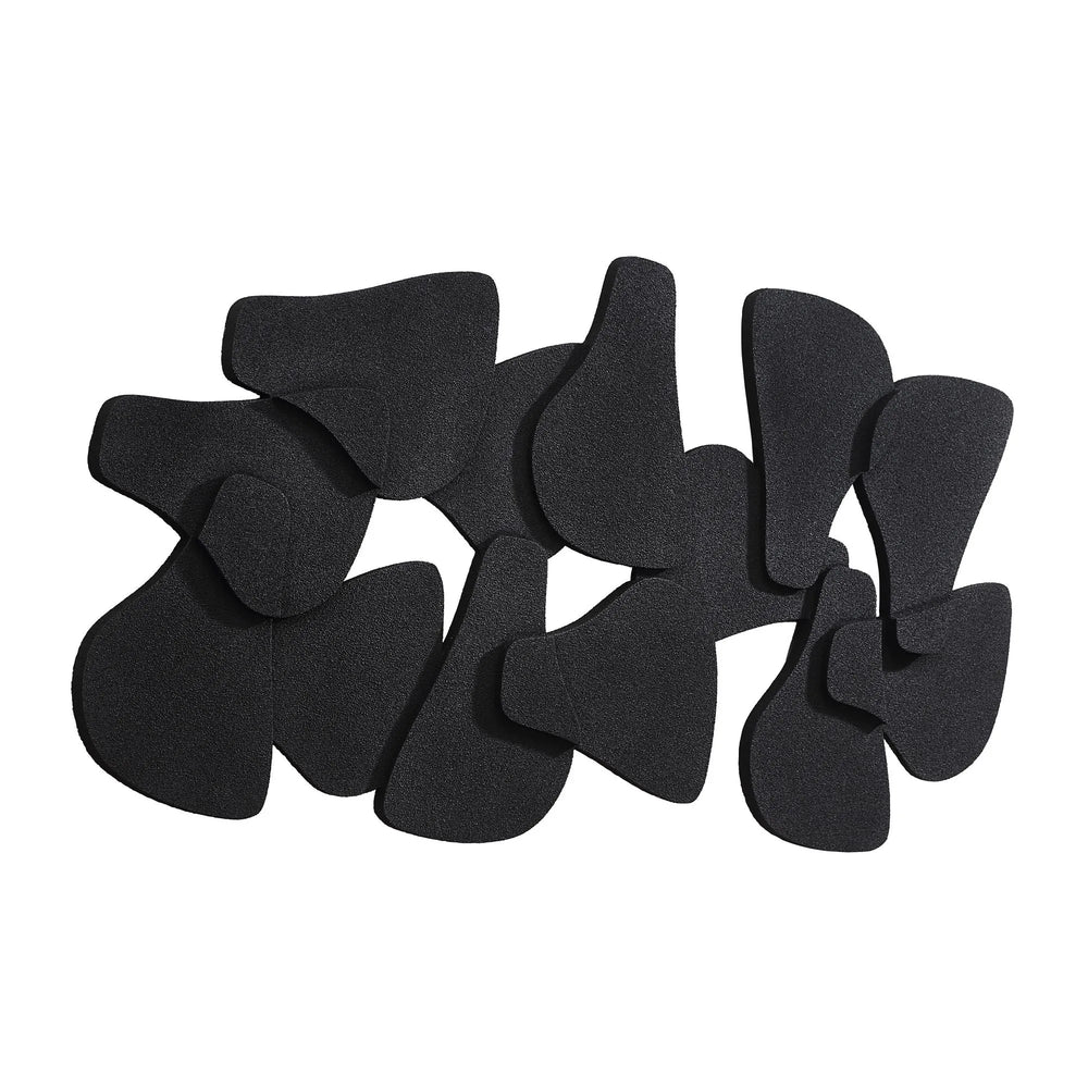 A collection of black, irregularly shaped biscuit accent wall decor pieces